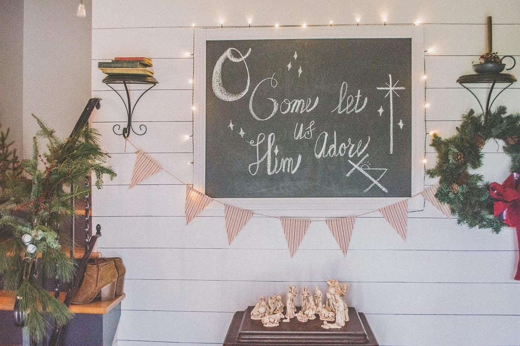 come let us him adore sign above nativity of jesus figurine set