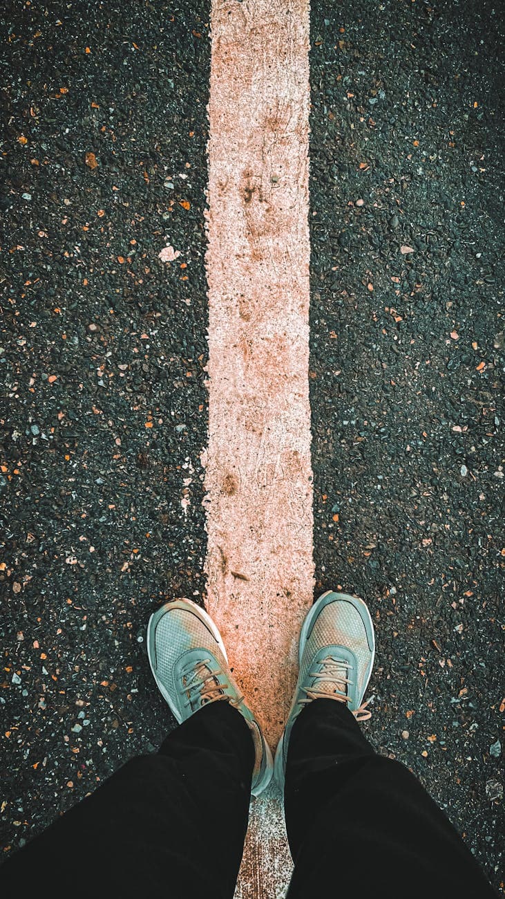 legs standing on asphalt